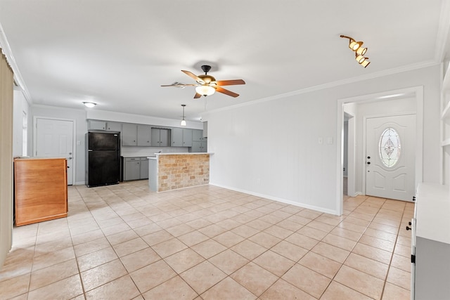 kitchen with black fridge, ceiling fan, crown molding, and gray cabinetry