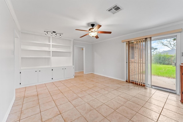 tiled spare room featuring crown molding, track lighting, ceiling fan, and built in shelves