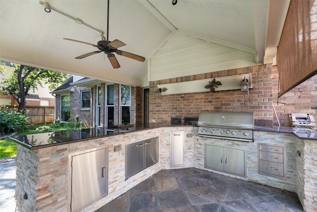 view of patio with area for grilling, ceiling fan, and an outdoor kitchen