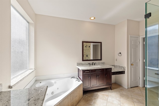 bathroom with tile patterned flooring, vanity, and shower with separate bathtub