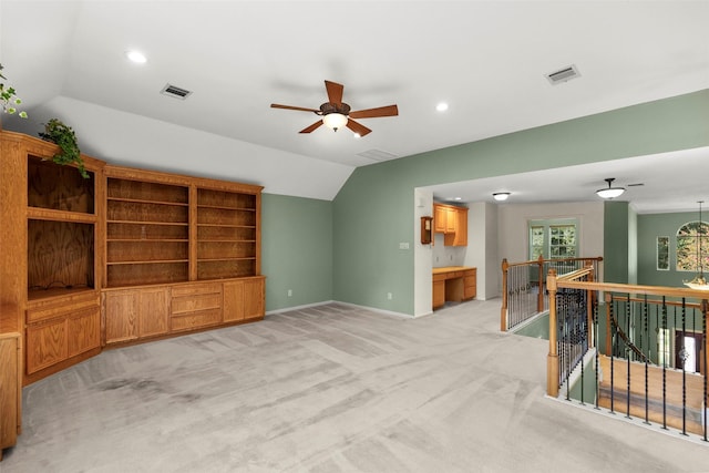 living room featuring ceiling fan, light colored carpet, and vaulted ceiling