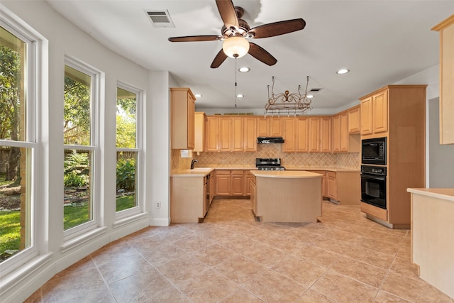 kitchen featuring a center island, light brown cabinets, backsplash, black appliances, and sink