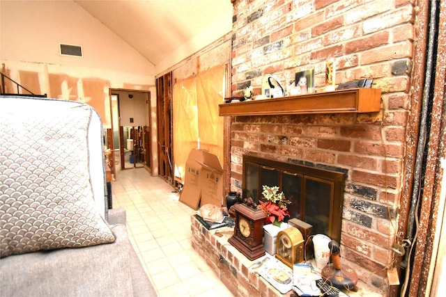 living room with tile patterned floors, lofted ceiling, and a fireplace