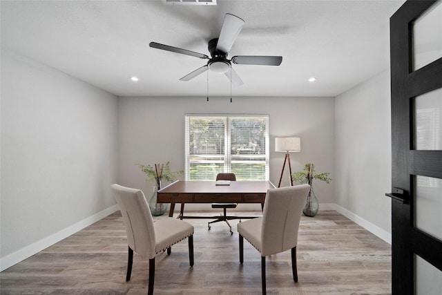 office space featuring ceiling fan and light hardwood / wood-style floors