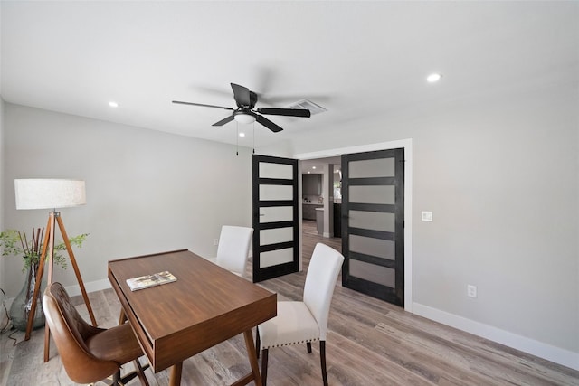 office space featuring ceiling fan and light hardwood / wood-style flooring