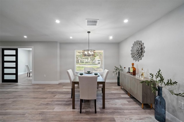 dining space featuring a chandelier and light wood-type flooring