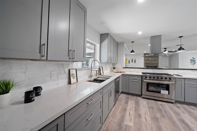 kitchen featuring gray cabinets, appliances with stainless steel finishes, sink, hanging light fixtures, and island exhaust hood