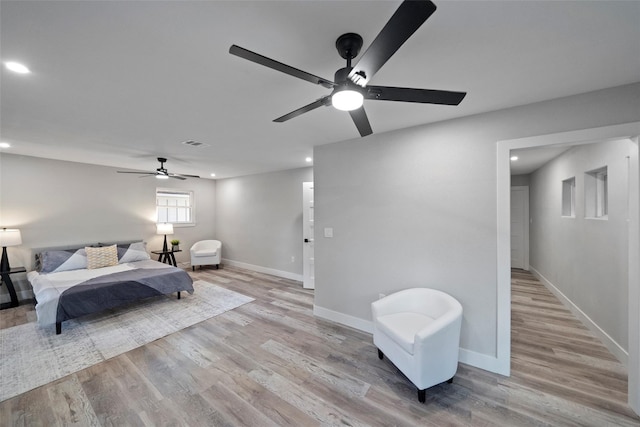 bedroom with ceiling fan and light hardwood / wood-style floors