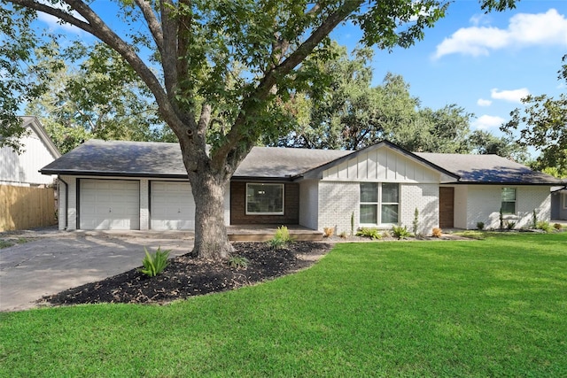 single story home with a front yard and a garage