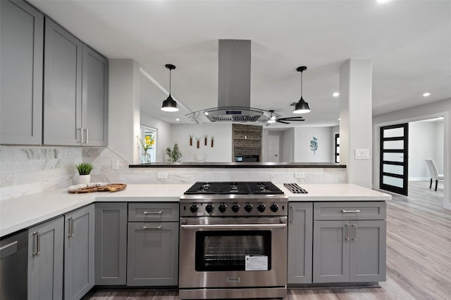 kitchen featuring gray cabinetry, island exhaust hood, hanging light fixtures, and stainless steel appliances