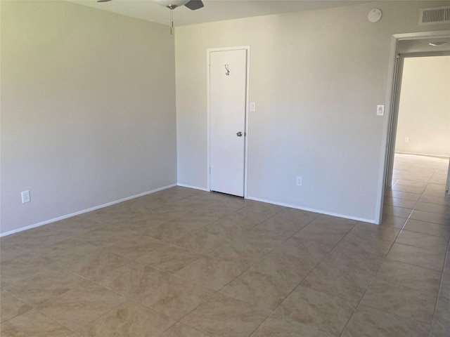 unfurnished room featuring tile patterned flooring and ceiling fan