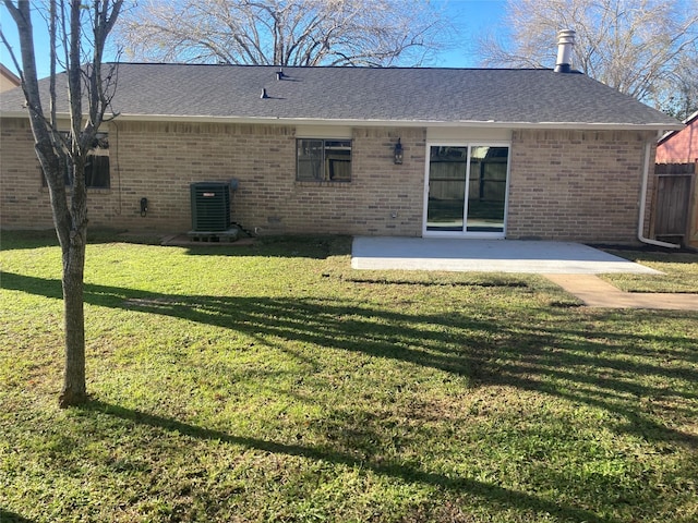 rear view of house featuring a yard, a patio, and central AC unit