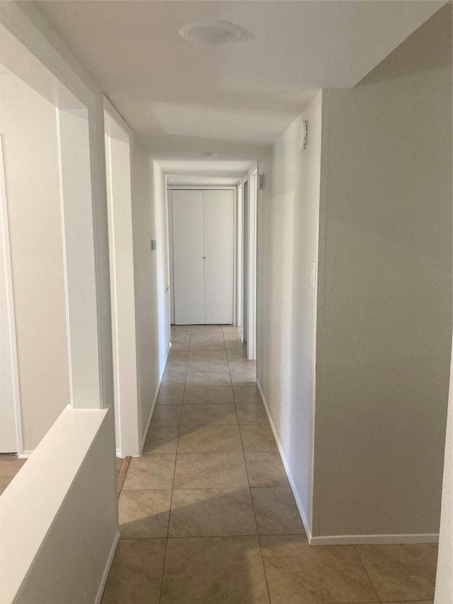 hallway with light tile patterned floors