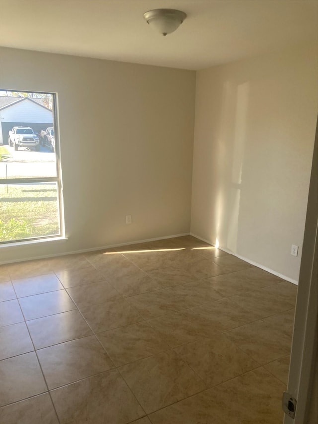 unfurnished room featuring tile patterned floors and a healthy amount of sunlight