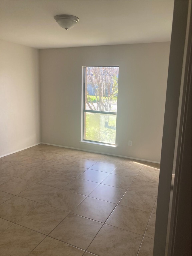 spare room featuring light tile patterned floors