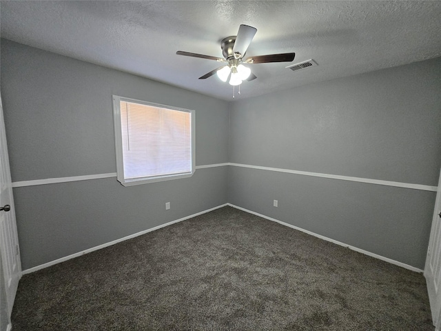 unfurnished room featuring dark colored carpet, ceiling fan, and a textured ceiling