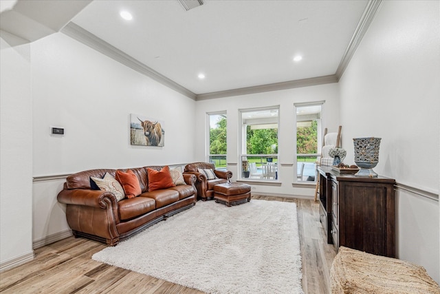 living room with light hardwood / wood-style floors and ornamental molding