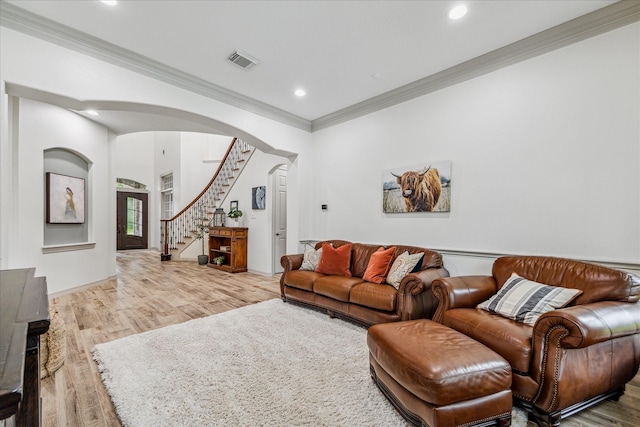 living room with hardwood / wood-style flooring and ornamental molding