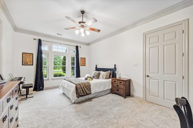 carpeted bedroom featuring ceiling fan and ornamental molding