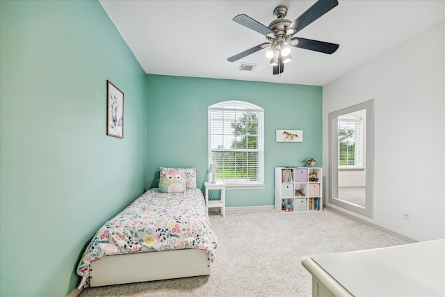 bedroom featuring ceiling fan, carpet floors, and multiple windows