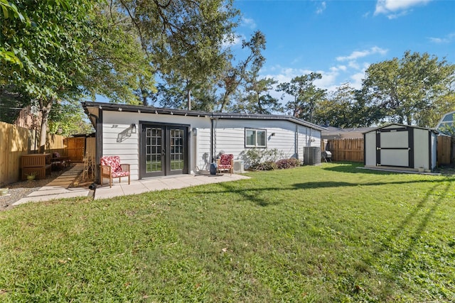 rear view of property featuring a patio area, a lawn, a storage unit, and central air condition unit