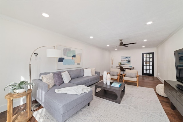 living room featuring ceiling fan, crown molding, and wood-type flooring