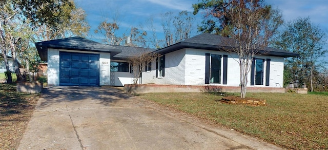 ranch-style house featuring a garage and a front yard