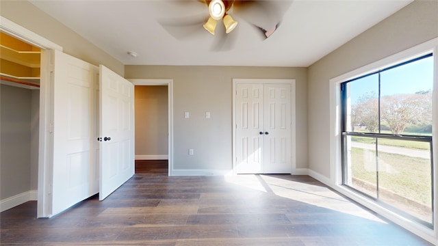 unfurnished bedroom featuring dark hardwood / wood-style flooring and ceiling fan