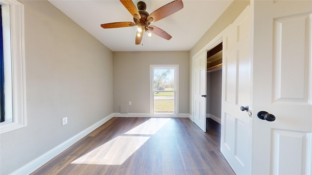 spare room featuring ceiling fan and dark hardwood / wood-style floors