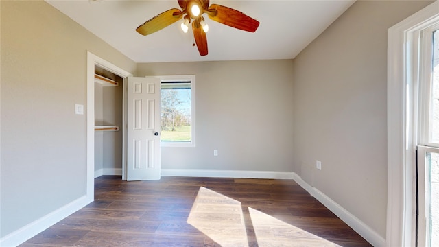 spare room with ceiling fan and dark wood-type flooring