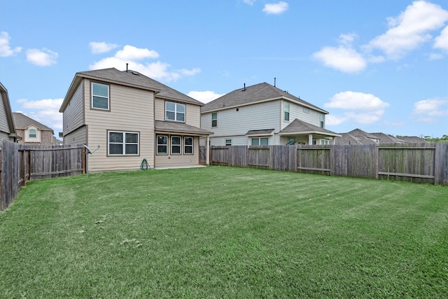 rear view of property with a yard