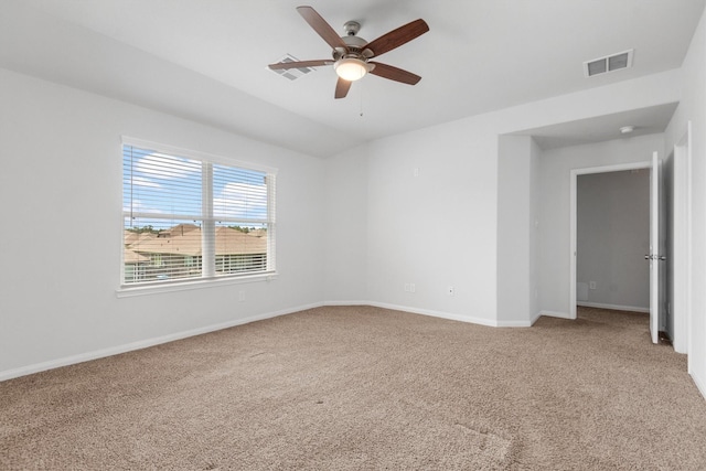 empty room featuring ceiling fan and carpet floors