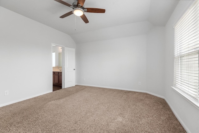 spare room featuring ceiling fan, lofted ceiling, and carpet floors