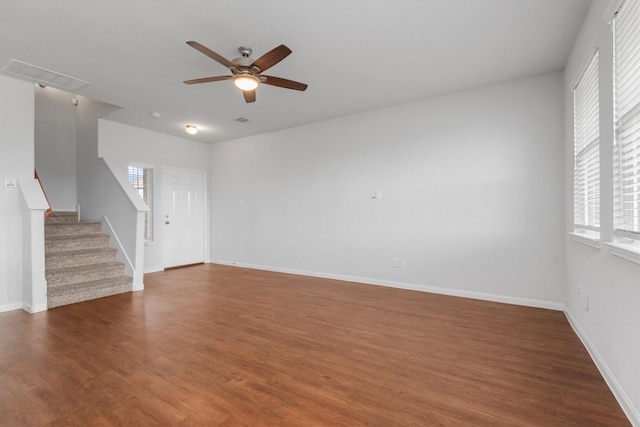 unfurnished living room featuring dark hardwood / wood-style floors and ceiling fan