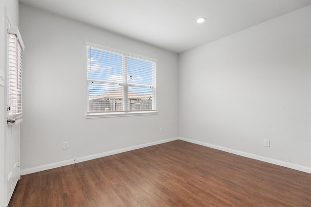 spare room featuring dark wood-type flooring