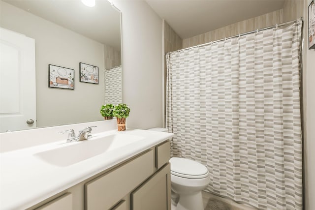 bathroom featuring vanity, a shower with shower curtain, and toilet