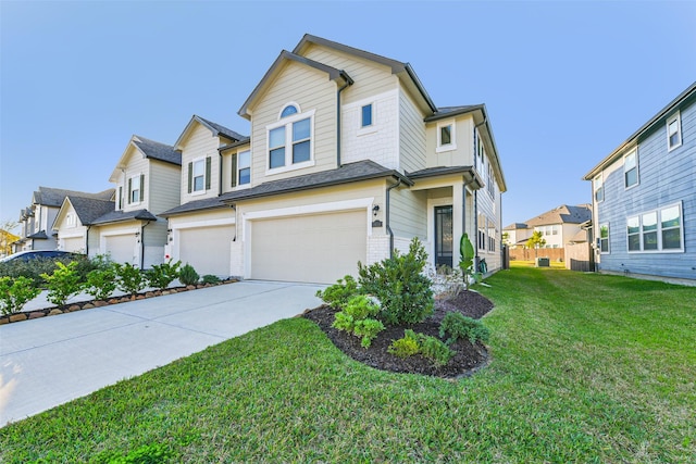 view of front of property with a front yard and a garage