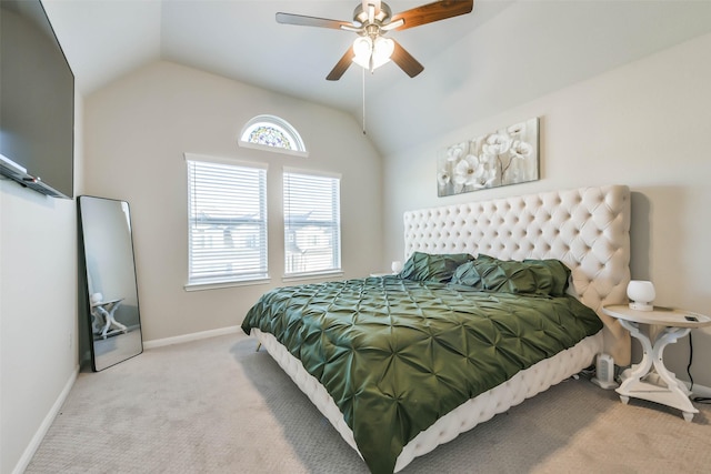 carpeted bedroom with ceiling fan and vaulted ceiling