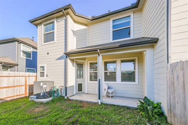 back of house with a yard, a patio, and central AC