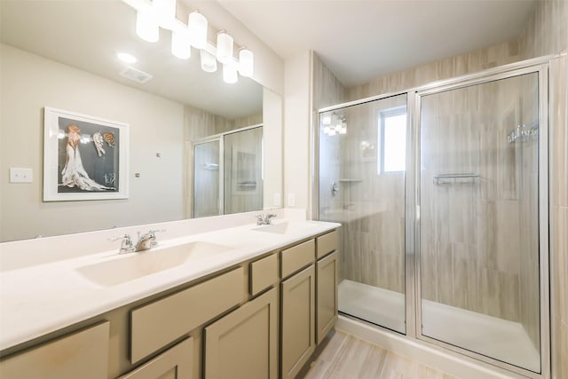 bathroom with vanity and a shower with shower door