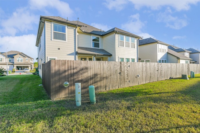 rear view of house featuring a yard