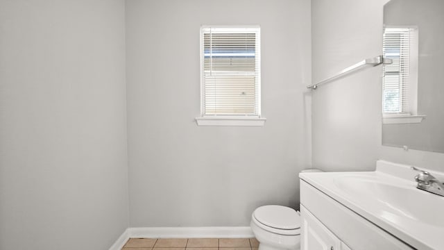 bathroom featuring tile patterned flooring, vanity, and toilet