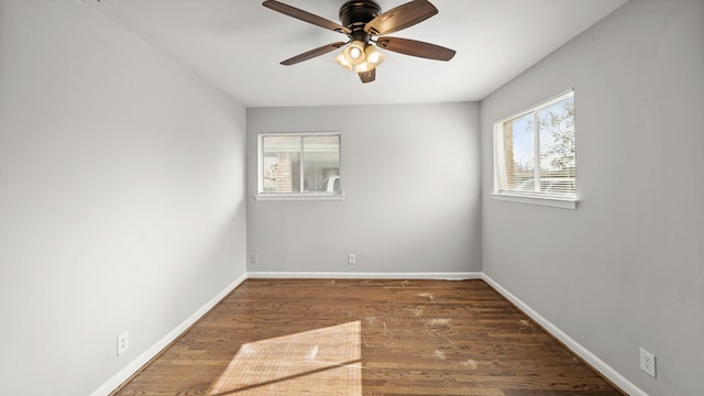 spare room featuring dark hardwood / wood-style flooring and ceiling fan