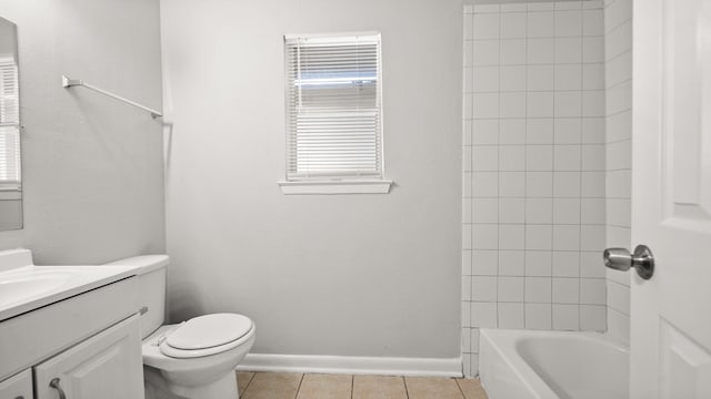 full bathroom featuring tile patterned floors, vanity, toilet, and tiled shower / bath combo