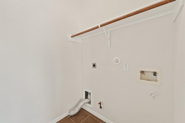 laundry room featuring washer hookup, dark tile patterned floors, gas dryer hookup, and electric dryer hookup