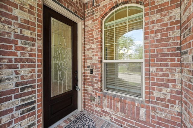 9147 Monarch Mist Ln, Houston, TX 77070 - doorway to property featuring brick siding