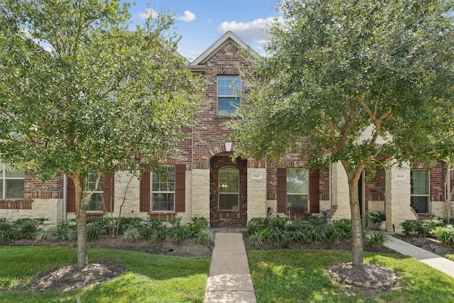9147 Monarch Mist Ln, Houston, TX 77070 - view of front of home with stone siding, brick siding, and a front lawn