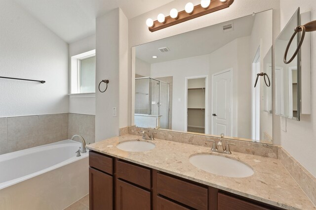 9147 Monarch Mist Ln, Houston, TX 77070 - full bathroom with a stall shower, double vanity, a bath, and a sink