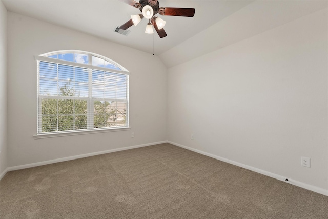 carpeted spare room featuring ceiling fan and lofted ceiling