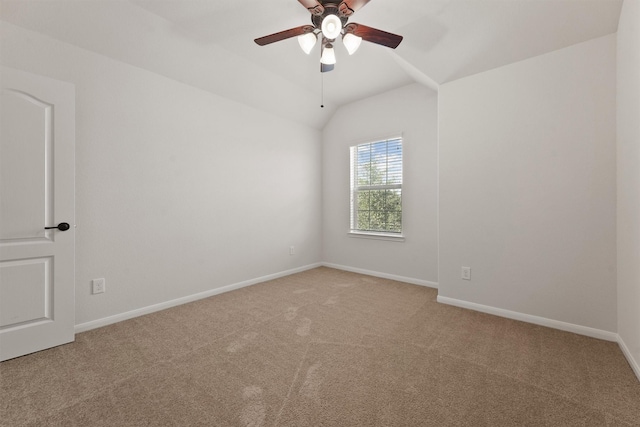 empty room with ceiling fan, carpet floors, and lofted ceiling